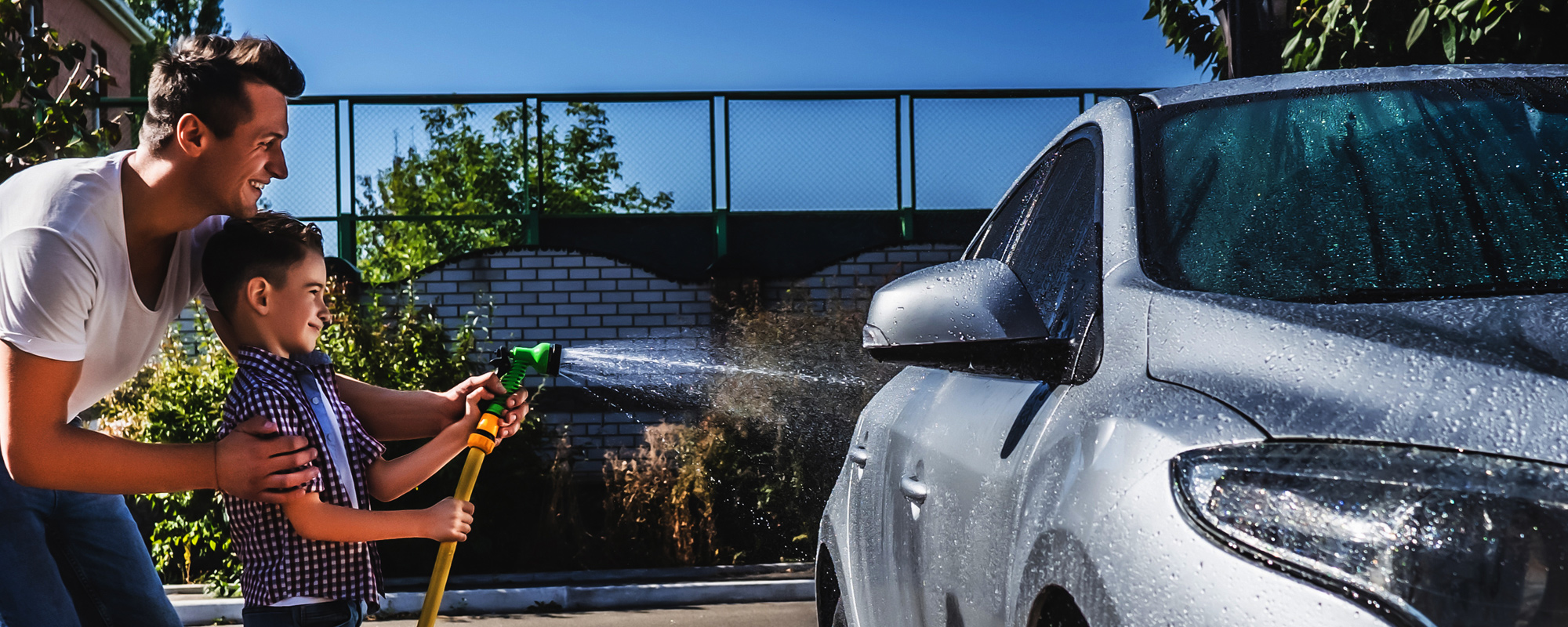 Dad and son washing a car