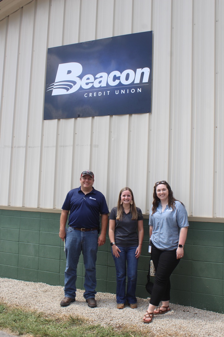 Kyle, Caitie, and Becca in front of Beacon sign