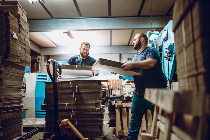 Late Night Cardboard Factory Shift Two Bearded men working at Cardboard Factory